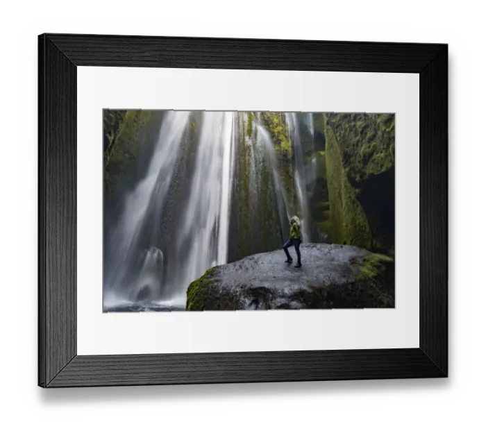 Framed Print : Iceland, Seljalandsfoss, woman standing on large rock in front of streaming falls Framed Print : Iceland, Seljalandsfoss, woman standing on large rock in front of streaming falls