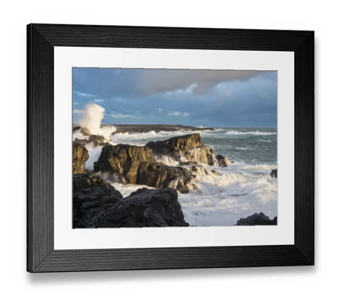 Framed Print : Coastline at Brimketill during stormy conditions at sunset