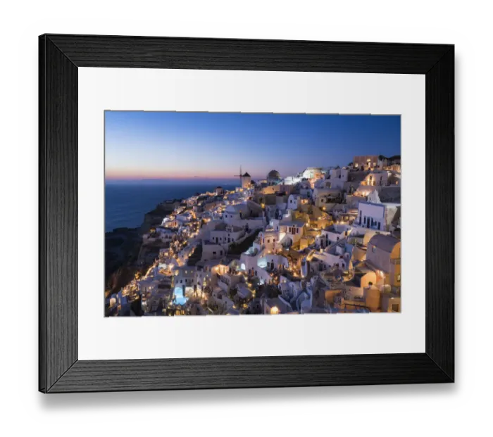 Framed Print : Greece, Santorini. The village of Oia glows in the post-sunset light as the town s Framed Print : Greece, Santorini. The village of Oia glows in the post-sunset light as the town s