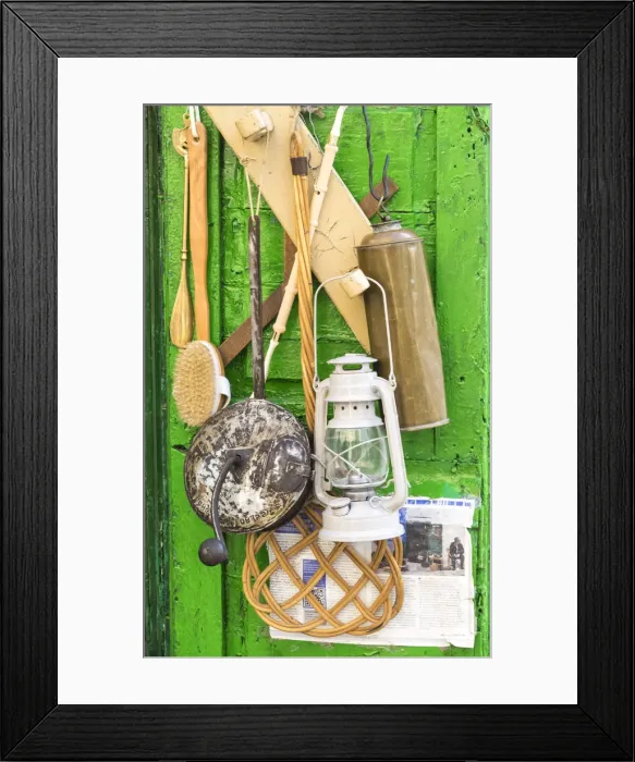 Framed Print : Items for sale hanging on the door of a small storefront in old town Ostuni