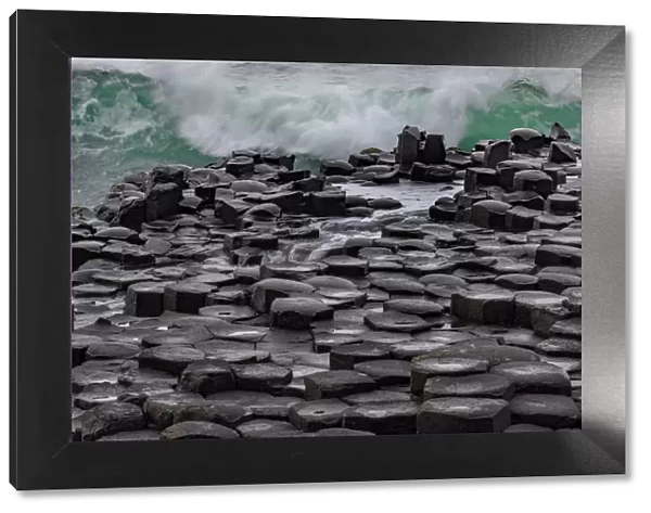 Waves crashing into basalt at the Giants Causeway in County Antrim, Northern