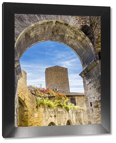 Medieval stone arch and tower, San Gimignano, Tuscany, Italy
