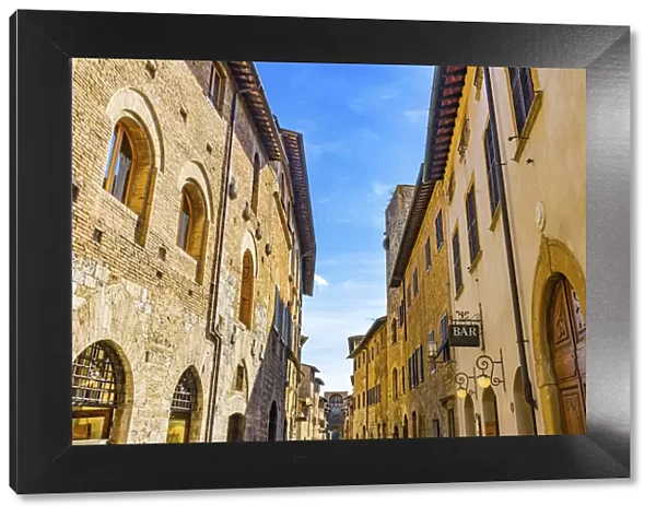 Hotel and bars on Medieval street, San Gimignano, Tuscany, Italy
