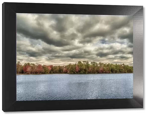 USA, New Jersey, Belleplain State Forest. Storm clouds over lake and forest. Credit as