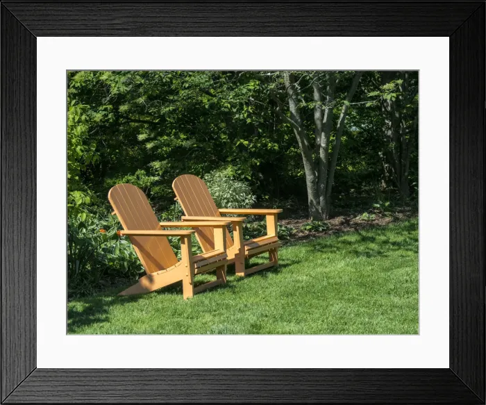 Framed Print : Pair of Adirondack chairs in a garden Framed Print : Pair of Adirondack chairs in a garden