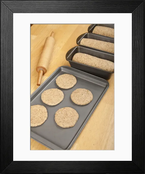 Framed Print : Multigrain bread dough formed into loaves and circles (to make hamburger buns) ready