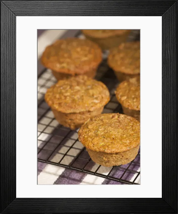 Framed Print : Zucchini muffins cooling on a wire rack above a striped tea towel Framed Print : Zucchini muffins cooling on a wire rack above a striped tea towel