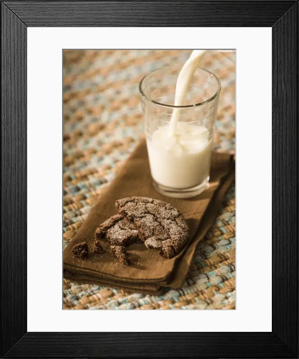 Framed Print : Snack of a homemade chocolate sugar cookie, with milk being poured into a glass Framed Print : Snack of a homemade chocolate sugar cookie, with milk being poured into a glass