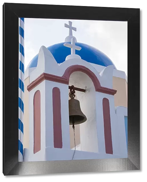 Blue domed Greek Orthodox church with bell in Oia, Santorini, Greece