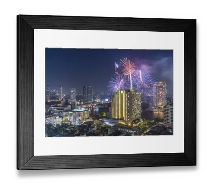 Framed Print : Thailand, Bangkok. Riverside, high angle skyline view with fireworks at dusk