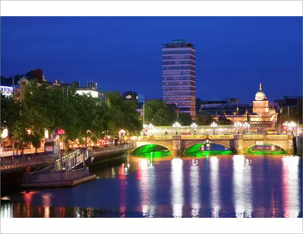 Europe, Ireland, Dublin. Ha Penny Bridge and River Liffey lit at night