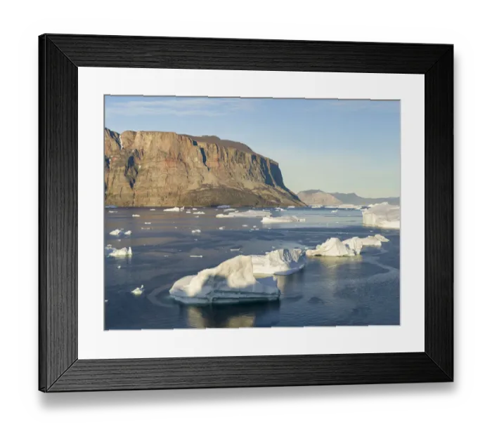 Framed Print : Iceberg in the Uummannaq Fjord System. Red cliffs of Storoen Island in the background Framed Print : Iceberg in the Uummannaq Fjord System. Red cliffs of Storoen Island in the background