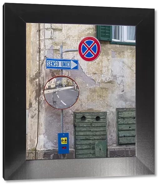 Old town house and traffic signs. Predazzo in valley Val di Fiemme