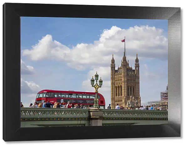 Classic double decker tour bus in London, England crossing the bridge River Thames with