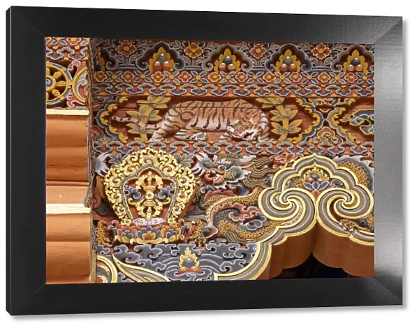 Bhutan. Traditional hand painted and carved wooden architectural detail with tiger