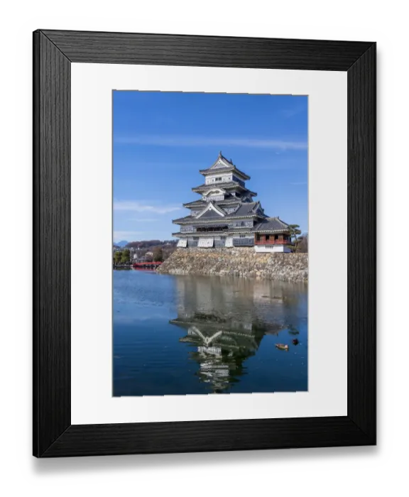 Framed Print : The Matsumoto Castle as seen from the bridge with the city buildings in the background