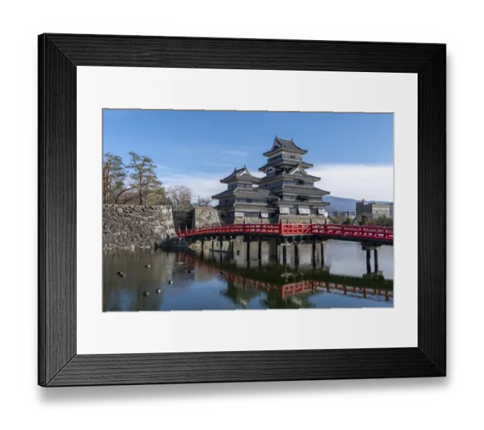 Framed Print : The Matsumoto Castle as seen from the bridge with the city buildings in the background Framed Print : The Matsumoto Castle as seen from the bridge with the city buildings in the background