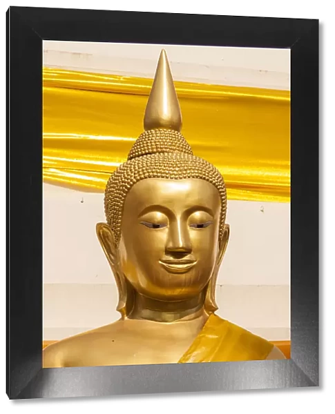 Thailand, Nong Khai Province. Head and shoulders of golden Buddha statue