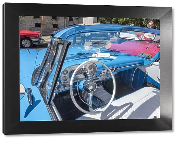 View into drivers seat of a classic convertible baby blue American car parked in