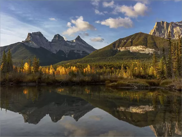 Three Sisters reflect into pool in Canmore, Alberta, Canada