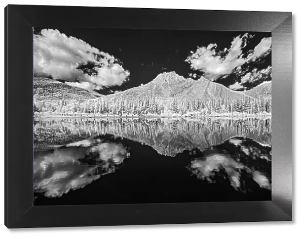 Canada, Alberta, Kananaskis Provincial Park. Black and white of clouds reflected in