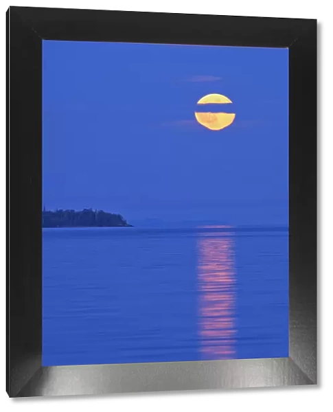 Canada, Ontario, Rossport. Full moon rising over Lake Superior