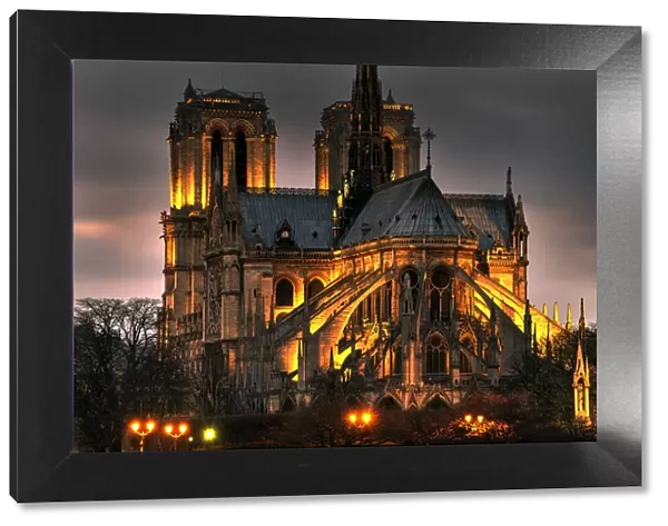 Notre Dame Cathedral and the Seine River shimmer in the Paris, France. night