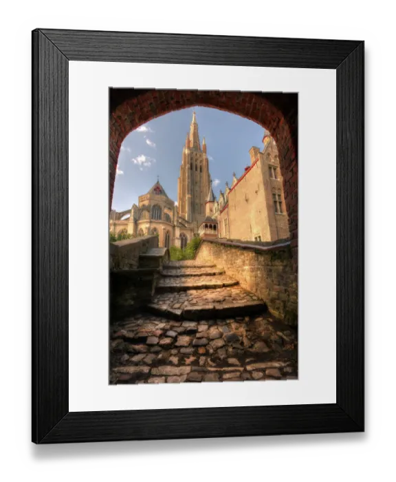 Framed Print : An arch leads to a church in Bruges, Belgium Framed Print : An arch leads to a church in Bruges, Belgium