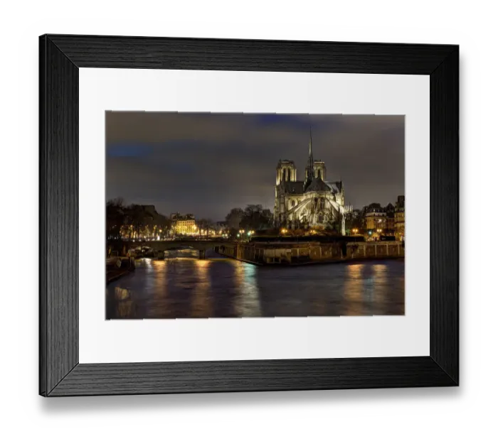 Framed Print : Notre Dame Cathedral and the Seine River shimmer in the Paris, France. night