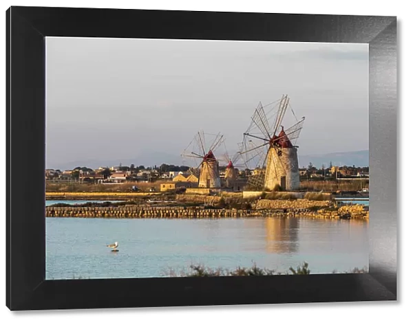 Italy, Sicily, Trapani Province, Marsala. Wind mills at the salt evaporation ponds in the