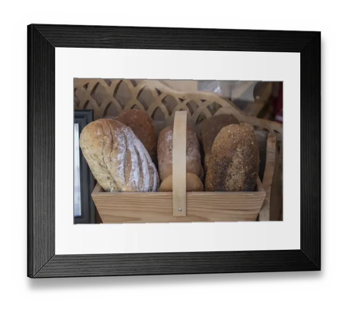 Framed Print : Basket of breads was found sitting on a bench outside a bakery in Glastonbury, England