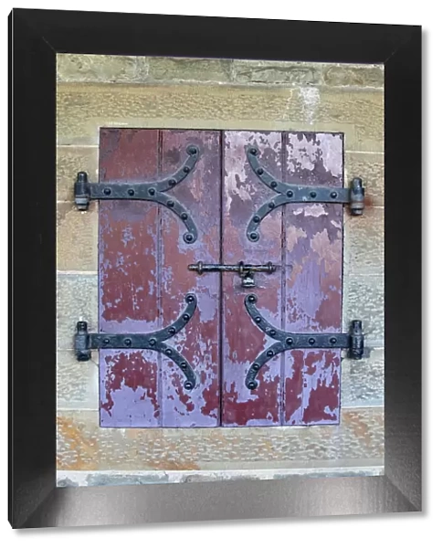 Doors with wrought iron hinges are found in an outdoor passageway at Cardiff Castle
