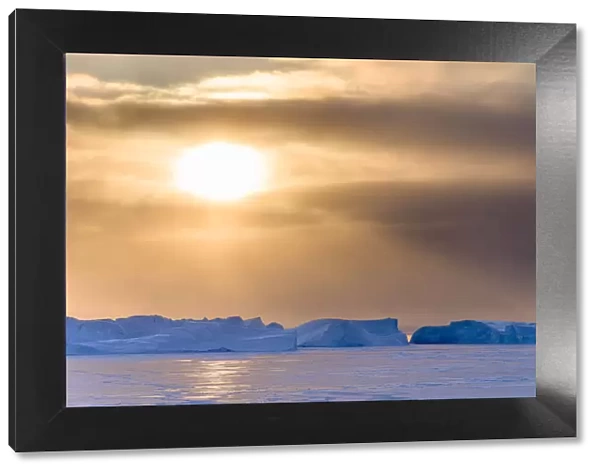 Sunset during winter at the Ilulissat Fjord, located in the Disko Bay in West Greenland