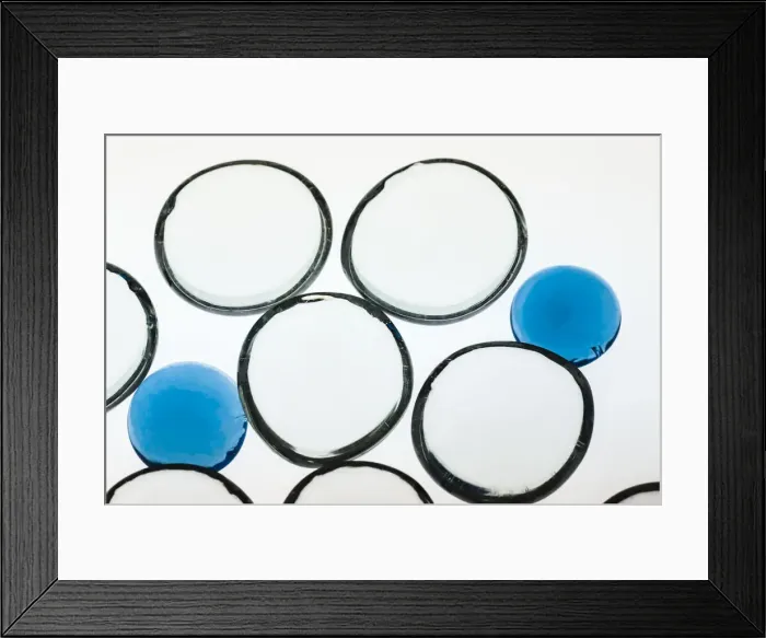 Framed Print : White and Blue glass pebbles with light