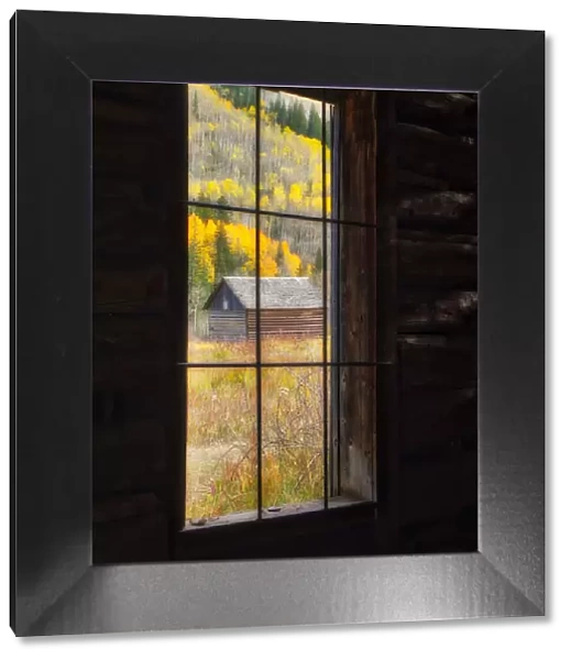 USA, Colorado. Looking out a window in the ghost town of Ashcroft in autumn near Aspen