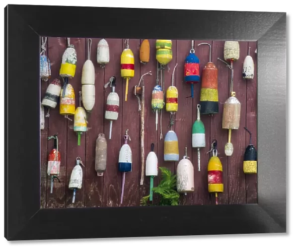 USA, Maine. Colorful buoys hanging on the exterior of a building