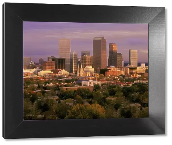 Denver, Colorado skyline glistens in early morning during sunrise against the Rocky
