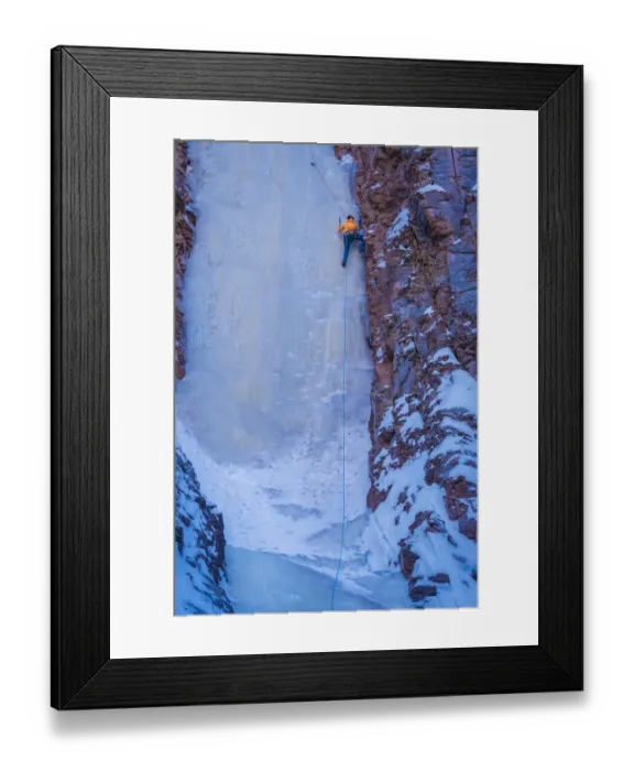 Framed Print : USA, Minnesota, Lake Superior. Climber scaling frozen waterfall on cliff