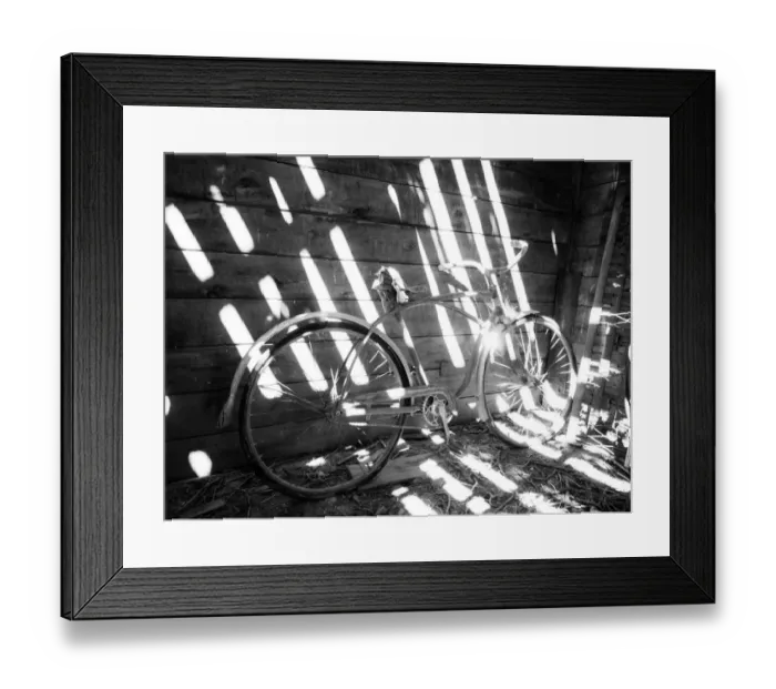 Framed Print : Old bicycle inside barn with shadows streaming