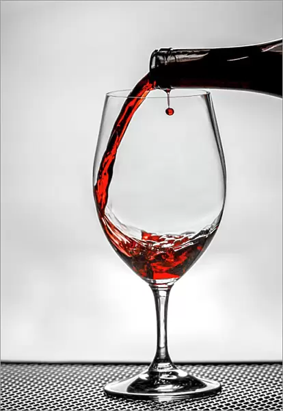 USA, Washington State, Spokane. Red wine poured into wine glass creates perfect round