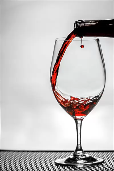 USA, Washington State, Spokane. Red wine poured into wine glass creates perfect round