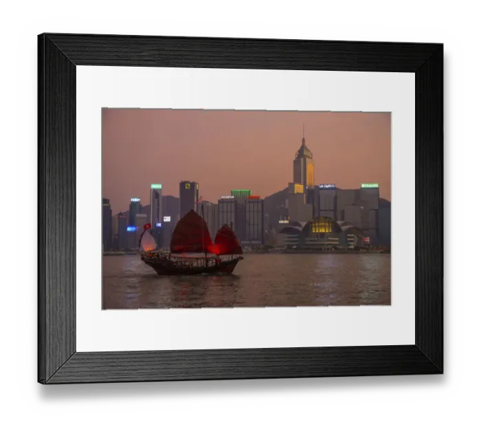 Framed Print : China, Hong Kong. Downtown buildings and boat in harbor at sunset