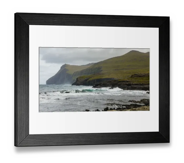 Framed Print : Europe, Faroe Islands. View of the northern coast pounded by storm surf from the village