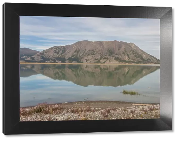 Canada, Yukon. Still water of Lake Kluane reflects Sheep Mountain on the Alaska Highway