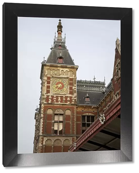Europe, Netherlands, Amsterdam. Looking up at clock tower of Central Station