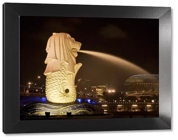 Singapore. Merlion statue spewing water at night