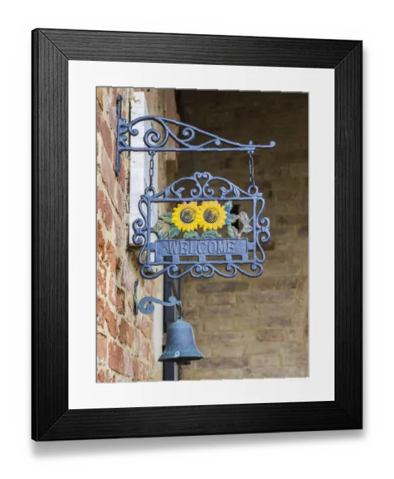 Framed Print : Italy, Tuscany. A wrought iron welcome sign in the village of Chiusure in the province of