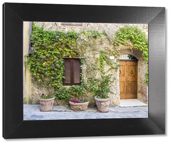 Italy, Tuscany. Entrance to a home in Tuscany decorated with potted plants