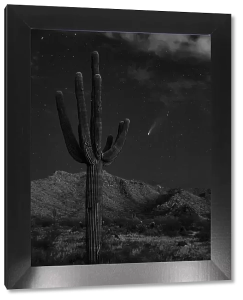 USA, Arizona, Buckeye. Comet Neowise spews trail over White Tank Mountains and desert