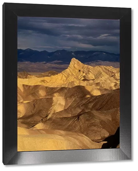 USA, California, Death Valley National Park. Clearing storm over sandstone formations at